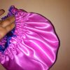 satin bonnet is a type of head covering made from smooth, shiny satin fabric, primarily used to protect hair while sleeping. It's especially popular among people with curly, coily, or textured hair,