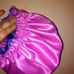 satin bonnet is a type of head covering made from smooth, shiny satin fabric, primarily used to protect hair while sleeping. It's especially popular among people with curly, coily, or textured hair,