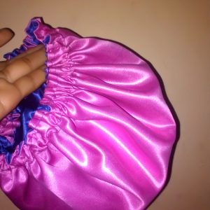 satin bonnet is a type of head covering made from smooth, shiny satin fabric, primarily used to protect hair while sleeping. It's especially popular among people with curly, coily, or textured hair,
